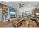 Inviting living room featuring a rustic fireplace and open layout to kitchen and dining at 2412 Regency Park Dr, Deland, FL 32724