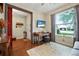 Comfortable living room featuring stylish decor, hardwood flooring, and a bright window view at 2412 Regency Park Dr, Deland, FL 32724