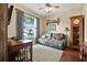 Relaxing living area with cozy seating, wood flooring, and a large window for natural light at 2412 Regency Park Dr, Deland, FL 32724