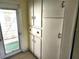 Hallway with white cabinets and an exterior door at 2647 Brookline Ave, New Smyrna Beach, FL 32168