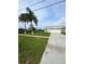 Beautiful home with a wide driveway, green lawn, and two palm trees standing in the front yard at 2689 Courtland Blvd, Deltona, FL 32738