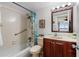 Cozy bathroom featuring a shower with a grab bar, and vanity with cherry-stained wood at 2711 N Halifax Ave # 264, Daytona Beach, FL 32118