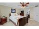 Inviting bedroom with a ceiling fan, neutral walls, and a view of an en-suite bathroom at 2711 N Halifax Ave # 264, Daytona Beach, FL 32118