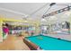Bright game room with a billiard table, tables, chairs, tile floor, and windows offering views at 2711 N Halifax Ave # 264, Daytona Beach, FL 32118
