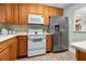 Classic kitchen with stainless steel refrigerator, white appliances, and light countertops at 2711 N Halifax Ave # 264, Daytona Beach, FL 32118