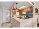 Well-lit kitchen featuring stainless steel appliances, bright countertops, and warm wood cabinetry at 2711 N Halifax Ave # 264, Daytona Beach, FL 32118