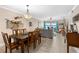 Open-concept living room and dining area with tile floors, fan, and water views at 2711 N Halifax Ave # 264, Daytona Beach, FL 32118