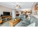 Spacious living room with ceiling fan, comfortable seating, and a view of the kitchen at 2711 N Halifax Ave # 264, Daytona Beach, FL 32118