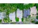 An aerial view of three well-maintained homes with mature trees and manicured lawns in a peaceful neighborhood at 275 Bayou Cir, Debary, FL 32713