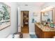 Bathroom with unique bowl sink, granite countertop, and view to staircase at 275 Bayou Cir, Debary, FL 32713