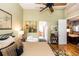 Bedroom featuring hardwood floors, a fan, an iron-frame bed, and a door leading to the living room at 275 Bayou Cir, Debary, FL 32713