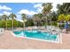 Community pool with clear blue water, lounge chairs, and well-maintained brick surroundings, perfect for relaxation at 275 Bayou Cir, Debary, FL 32713