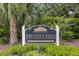 Entrance sign for River Oaks Marina Village, surrounded by greenery at 275 Bayou Cir, Debary, FL 32713