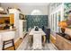 Open dining room space with chandelier, tall window, hardwood floors, and elegant blue wallpaper at 275 Bayou Cir, Debary, FL 32713