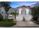 Charming two-story home featuring a two-car garage and lush landscaping with palm trees at 275 Bayou Cir, Debary, FL 32713