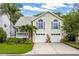 Charming two-story home featuring a two-car garage and lush landscaping with palm trees at 275 Bayou Cir, Debary, FL 32713