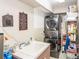 This laundry room features a sink, stacked washer and dryer, and shelving for convenient storage solutions at 275 Bayou Cir, Debary, FL 32713