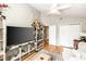 Bright living room with hardwood floors, TV, and modern decor at 275 Bayou Cir, Debary, FL 32713