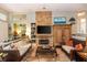 Comfortable living room with a stone fireplace, a decorative rug and hardwood floors throughout at 275 Bayou Cir, Debary, FL 32713