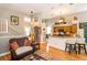 Spacious living area with hardwood floors, stairway, light fixtures and view into the kitchen at 275 Bayou Cir, Debary, FL 32713