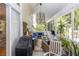 A cozy screened in lanai with comfortable seating, a ceiling fan, a TV, and lots of tropical plants at 275 Bayou Cir, Debary, FL 32713