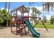A fun playground with a slide and swing set surrounded by lush greenery, perfect for outdoor play at 275 Bayou Cir, Debary, FL 32713