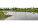 Picturesque view of the waterfront featuring calm water and lush marsh vegetation at 275 Bayou Cir, Debary, FL 32713