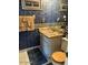 Cozy bathroom featuring a vanity with sink, toilet, decorative wallpaper, and framed beach-themed art at 2898 Ocean Shore Blvd # 603, Ormond Beach, FL 32176