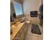 Tiled bathroom featuring a vanity, toilet, and window, offering a functional and comfortable space at 2898 Ocean Shore Blvd # 603, Ormond Beach, FL 32176