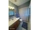 Bathroom featuring a vanity, toilet, shower with a curtain, providing a clean and private space for personal care at 2898 Ocean Shore Blvd # 603, Ormond Beach, FL 32176
