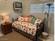 Cozy bedroom with a daybed, small television, and soft lighting, perfect for relaxing and unwinding at 2898 Ocean Shore Blvd # 603, Ormond Beach, FL 32176