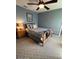 Bedroom with carpet flooring, ceiling fan, wooden bed frame, side table and beach themed accents at 2898 Ocean Shore Blvd # 603, Ormond Beach, FL 32176