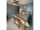 Bedroom with a wooden bed, carpet flooring, ceiling fan, and a decorative painting enhancing its inviting atmosphere at 2898 Ocean Shore Blvd # 603, Ormond Beach, FL 32176
