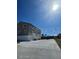 Exterior of a two-story building with a large paved parking area and blue sky at 2898 Ocean Shore Blvd # 603, Ormond Beach, FL 32176