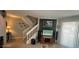 Inviting living area featuring staircase, entertainment center, and neutral tones at 2898 Ocean Shore Blvd # 603, Ormond Beach, FL 32176