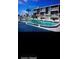 Exterior shot of complex with a large community pool and towering palm trees at 2898 Ocean Shore Blvd # 603, Ormond Beach, FL 32176