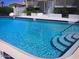 Refreshing community pool with steps for easy access and ample space for relaxation at 2898 Ocean Shore Blvd # 603, Ormond Beach, FL 32176