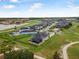 Expansive aerial view of a beautiful community with golf course, pool, and lush landscaping at 2948 Bella Flore Ter, New Smyrna Beach, FL 32168