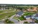 An aerial view of a home with lush landscaping in a golf community at 2948 Bella Flore Ter, New Smyrna Beach, FL 32168