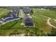An aerial view of a home featuring a screened pool, fenced backyard and tropical landscaping at 2948 Bella Flore Ter, New Smyrna Beach, FL 32168