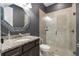 This bathroom showcases a granite countertop, stylish mirror, and glass-enclosed shower for a spa-like experience at 2948 Bella Flore Ter, New Smyrna Beach, FL 32168