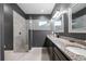 A bathroom boasts a glass shower and plenty of granite countertop space at 2948 Bella Flore Ter, New Smyrna Beach, FL 32168
