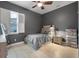 Cozy bedroom featuring a comfortable bed, shuttered window, and neutral tones for a relaxing ambiance at 2948 Bella Flore Ter, New Smyrna Beach, FL 32168