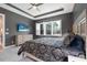 The bedroom has a TV, a view, and great natural light from the windows at 2948 Bella Flore Ter, New Smyrna Beach, FL 32168
