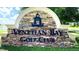 Venetian Bay Golf Club stone entrance with lush greenery and beautiful signage at 2948 Bella Flore Ter, New Smyrna Beach, FL 32168
