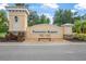 Entrance to Portofino Reserve boasts a beautiful sign, palm trees and manicured landscaping at 2948 Bella Flore Ter, New Smyrna Beach, FL 32168
