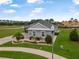 Beautiful home with a manicured lawn, professional landscaping, and brick paver driveway at 2948 Bella Flore Ter, New Smyrna Beach, FL 32168