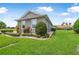 Side view of the house showing the lush lawn and landscaping at 2948 Bella Flore Ter, New Smyrna Beach, FL 32168
