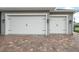 Attached three-car garage with brick paved driveway at 2948 Bella Flore Ter, New Smyrna Beach, FL 32168