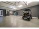 Large garage with epoxy floor provides ample space for a golf cart and storage at 2948 Bella Flore Ter, New Smyrna Beach, FL 32168